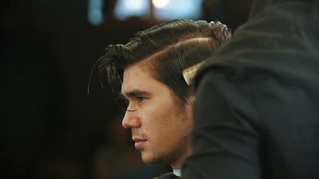 Man having a haircut at the barber, close up