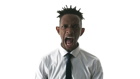 Man in a suit letting out his anger.