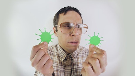 Man in glasses looking at forms of coronavirus.