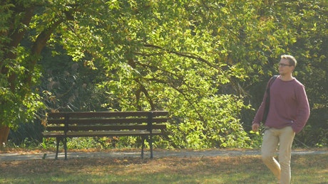 Man in glasses walking on the park