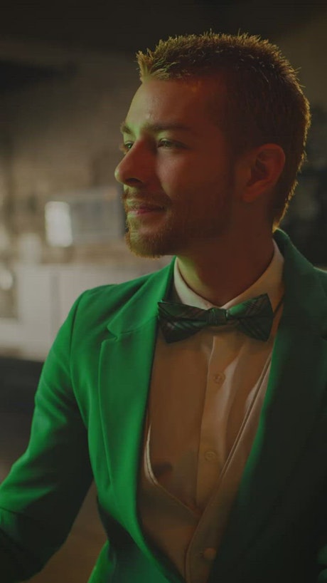 Man in green suit drinking on st patrick's day.