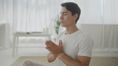 Man in peaceful mind meditation at home.