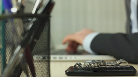 Man in suit working on a computer in an office.