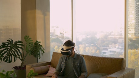 Man moves with virtual reality glasses.