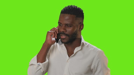 Man on a green screen on a phone call