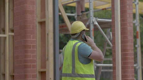 Man on the phone near a construction site
