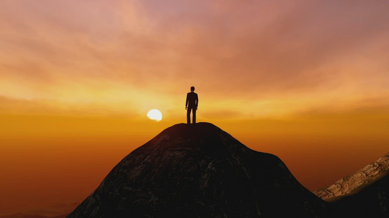 Man on the top of a mountain watching the sunset - Free Stock Video