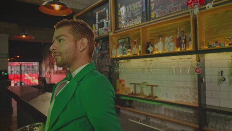 Man partying on St. Patrick's Day in a bar.