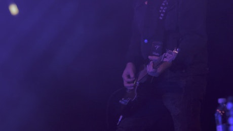 Man playing the guitar on stage