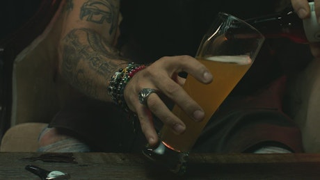 Man pouring beer into a glass.