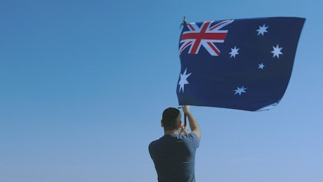 Man proudly waving the Australian flag.