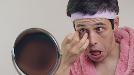 Man removes anti-dark circles treatment
