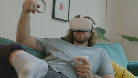 Man resting while using virtual reality glasses.
