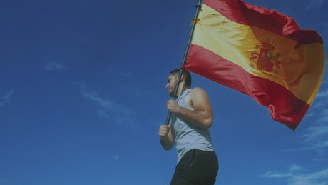 Man running with Spanish flag