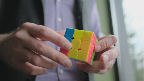 Man solving a rubik's cube.