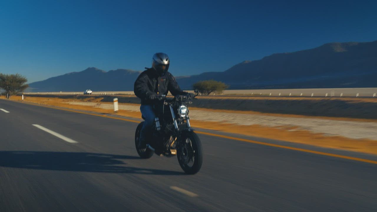 Man speeding a judi bola slot  road on a motorcycle