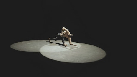 Man stretches in the spotlight