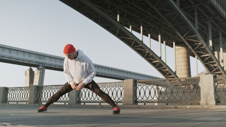 Man stretching his body before an urban workout