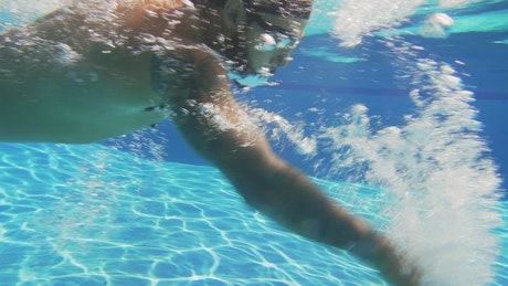 Man swimming in a pool.