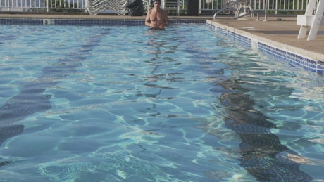 Man swimming in an outdoor pool