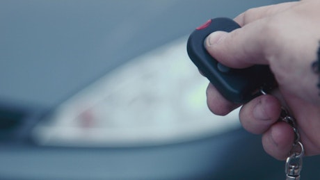Man turning on the alarm of a car