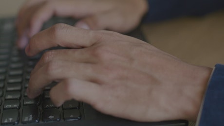 Man typing on a computer.