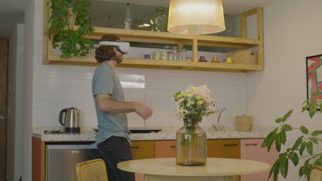 Man using virtual reality glasses at home