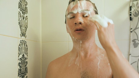 Man washing his hair while bathing