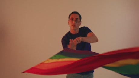 Man waving LGBT pride flag.