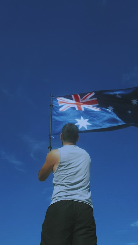 Man waving the Australian flag.