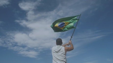 Man waving the flag of Brazil.