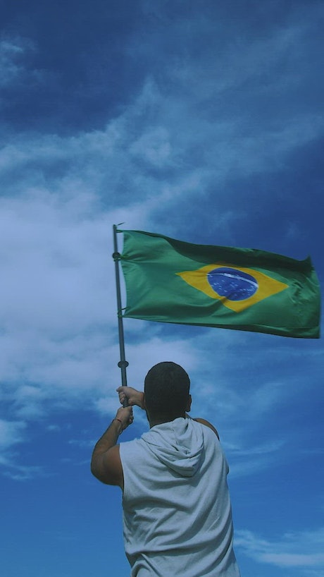 Man waving the flag of Brazil in slow motion