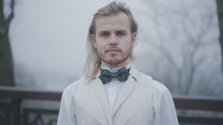 Man wearing a bowtie staring forwards at the camera.