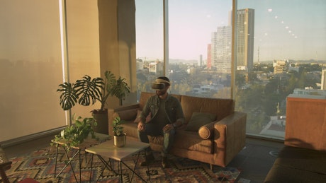Man wearing augmented reality glasses in an apartment