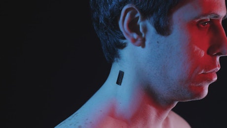 Man with a microchip implant in his neck.