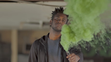 Man with green smoke bomb
