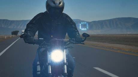 Man with helmet speeding a motorcycle.