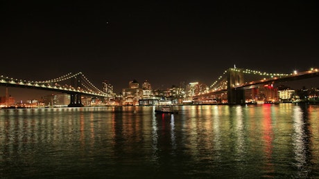 Manhattan and Brooklyn bridges at night.