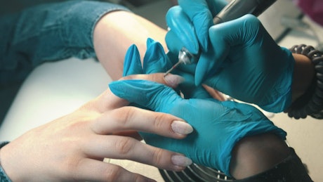 Manicurist working on clients hands