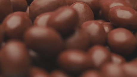 Many chocolate beans slowly rotating.