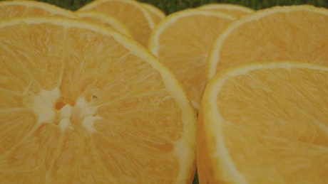 Many half oranges in a close shot