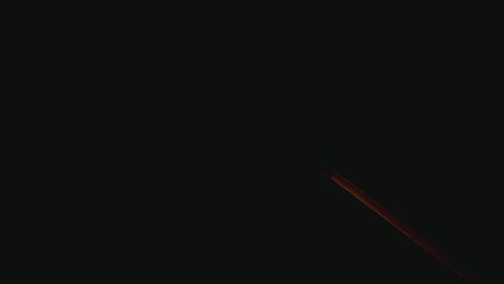 Match burning in a black background.