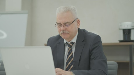 Mature man working in the administrative tasks.