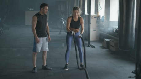 Mature woman working out with her trainer.