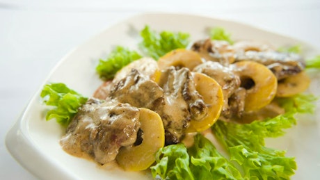 Meat dish with pineapple and lettuce.