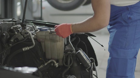 Mechanic repairing a car engine.