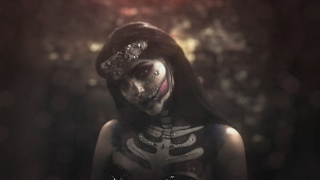 Medium shot of a young woman dressed as catrina.