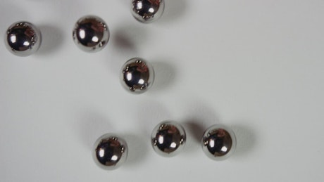 Metal pellets on white surface.