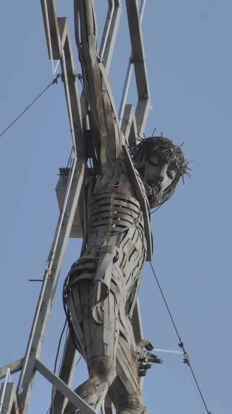 Metal sculpture of a crucified Jesus Christ.