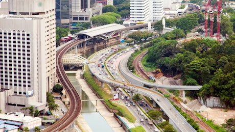 Metro station and highway traffic in Kuala Lumpur.